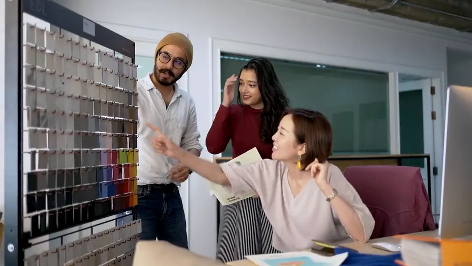 A design team choosing colours together at a wall of swatches